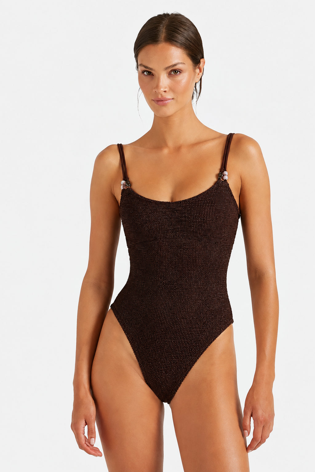 Woman wearing a Hunza G brown crinkle fabric one piece set on a white background