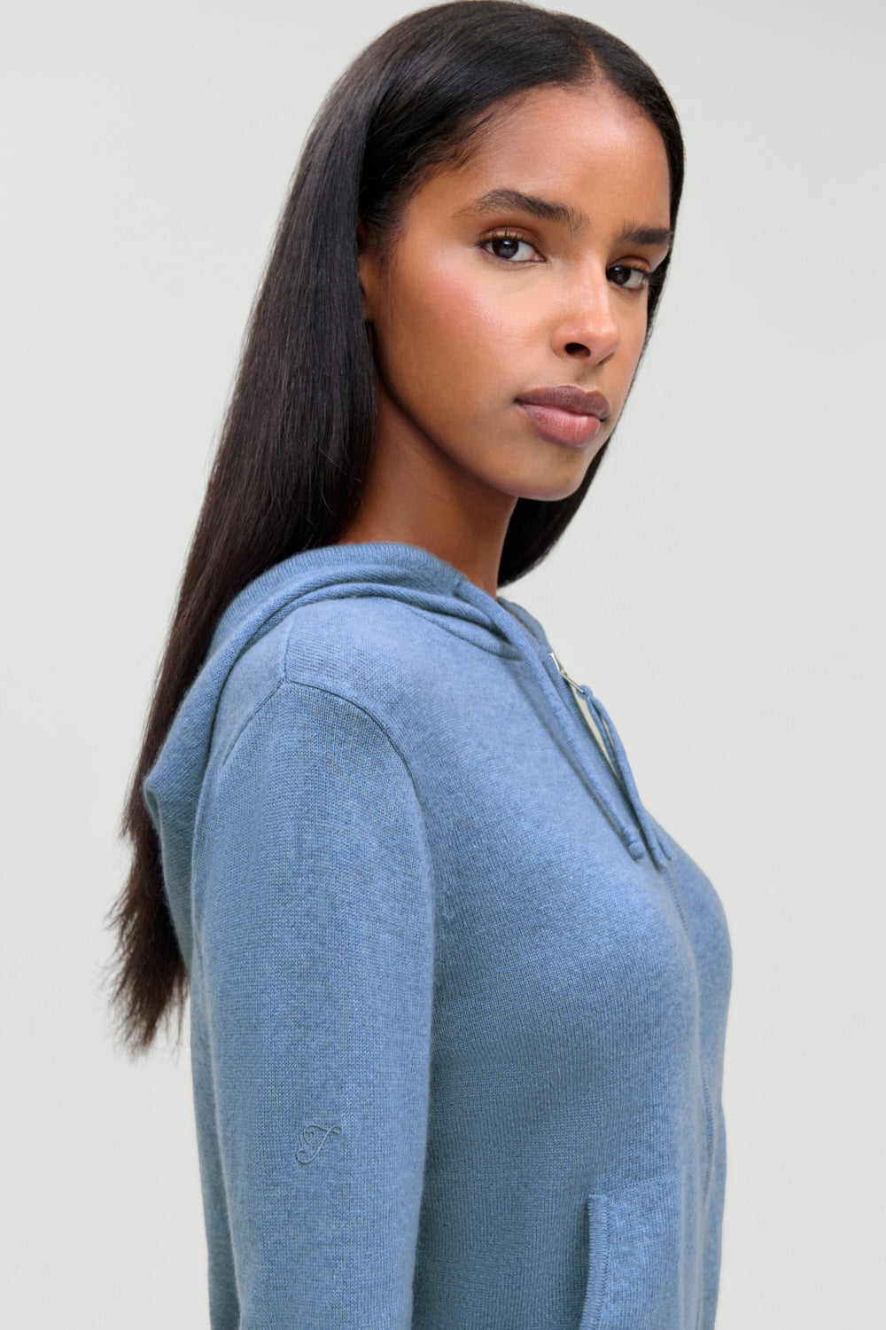 Topanga cashmere zip up hoodie in Blue Lake, second side view showing ribbed cuffs and waist